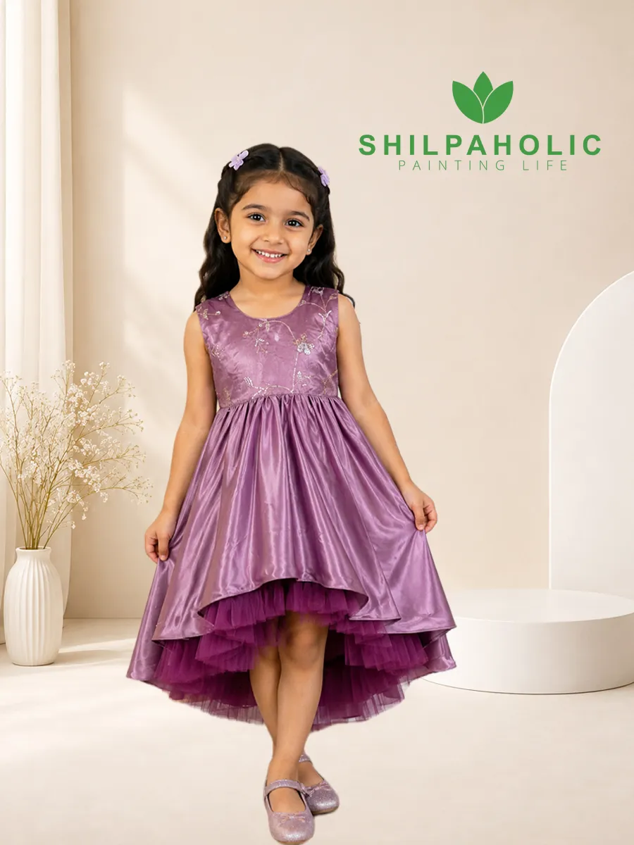 Purple High Low Frock Little girl wearing Shilpaholic purple high low party frock dress with floral embroidery and tulle underskirt